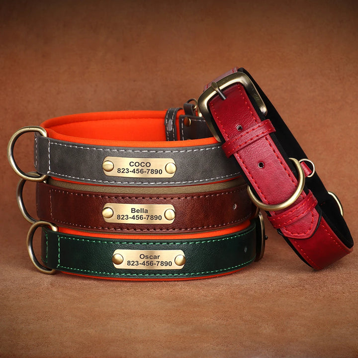 Set of leather dog collars with engraved names on a brown background