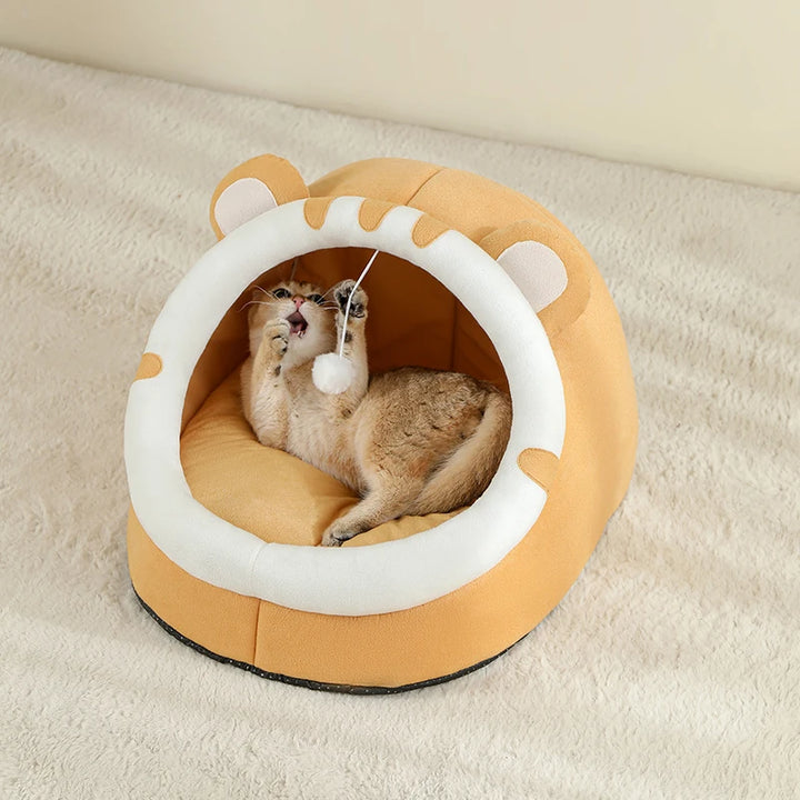Cat playing with a orange and white Cat Bed Cave