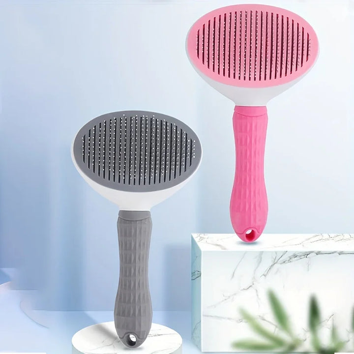 Two dog and cat hair brushes, one pink and one gray