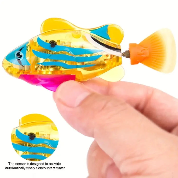 Cat fish toy with a hand holding the fish to see the sensor 