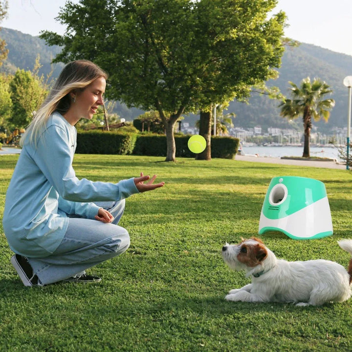 Woman playing with dog with Automatic Dog Ball Launcher