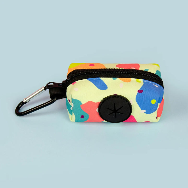 Colorful beige Dog Poop Bag Holder with a carabiner on a light blue background