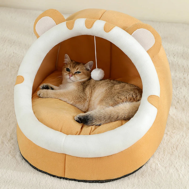 Side view of cat lying in an orange Cat Bed Cave