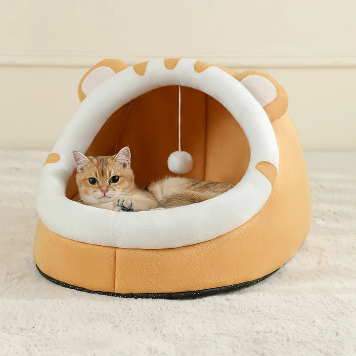 Cat lying in a yellow and white Cat Bed Cave