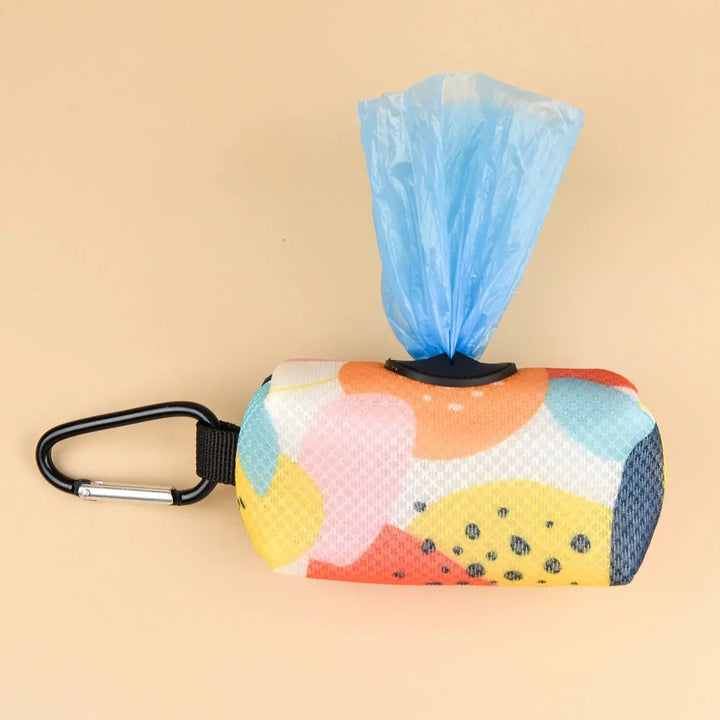 Multicolored dog waste bag holder with a blue bag on a beige background