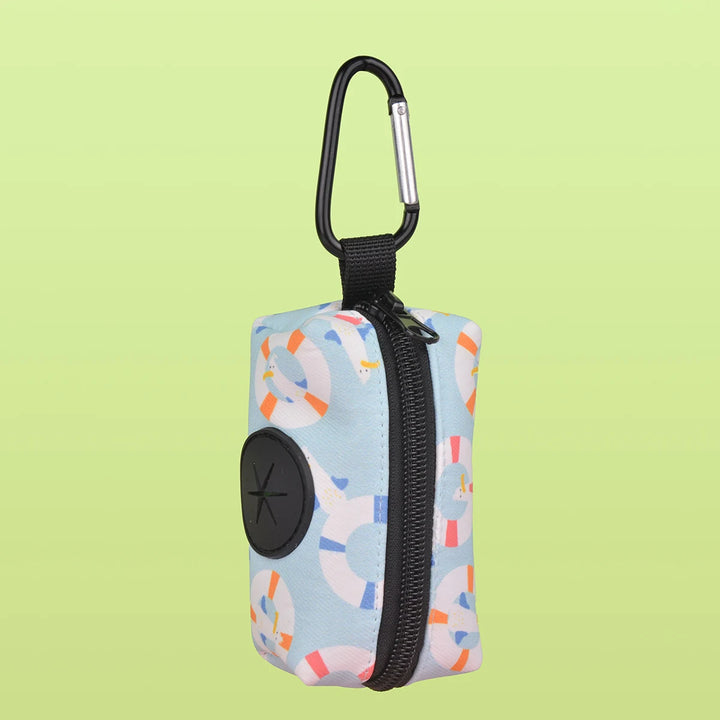 Small Dog Poop Bag Holder with colorful design and carabiner on a light green background