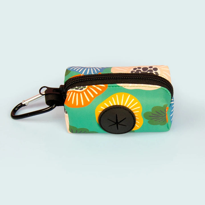 Colorful green Dog Poop Bag Holder with floral design on a light blue background