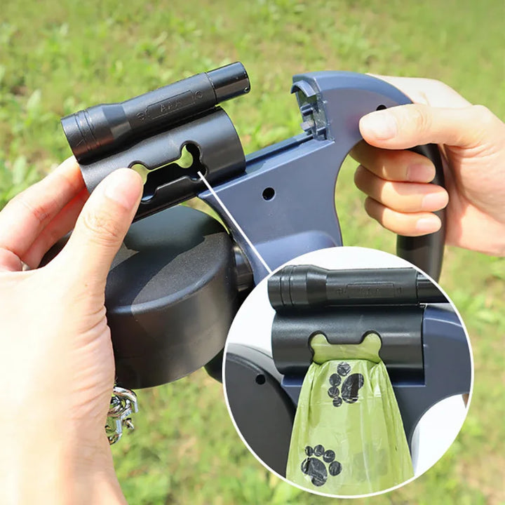 Pet waste bag dispenser on a Black retractable double dog leash 